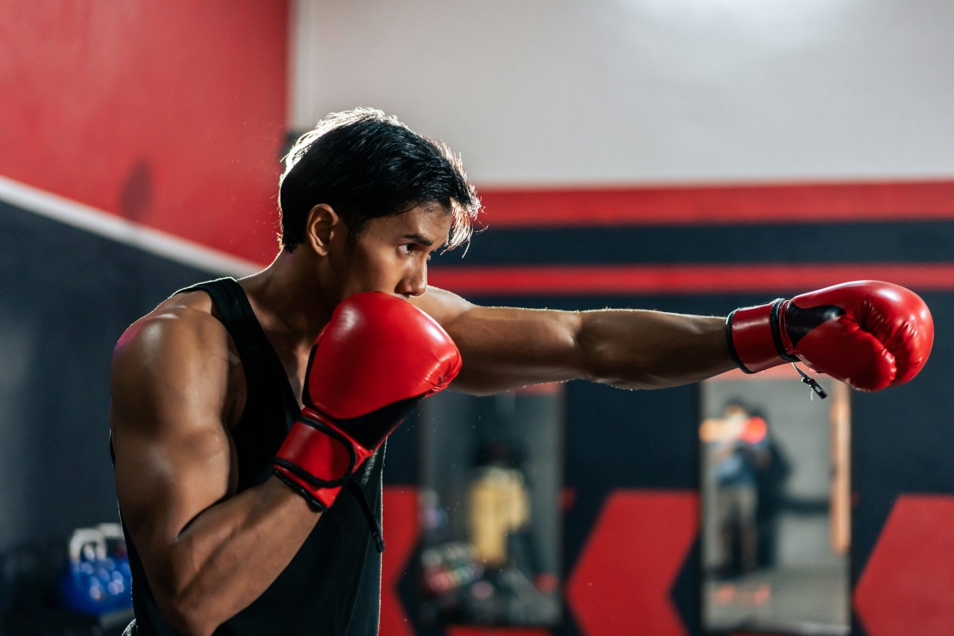 young-man-boxing-exercising-in-fitness-gym