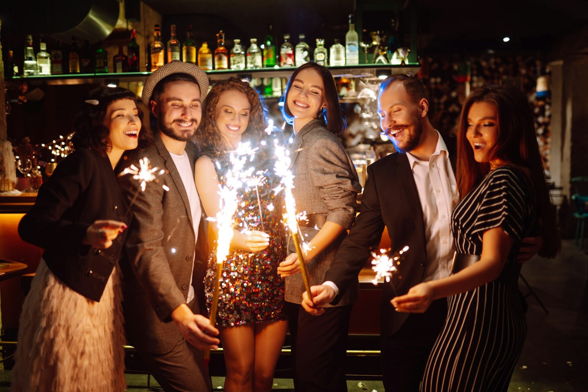 group-of-happy-people-enjoying-party-with-fireworks